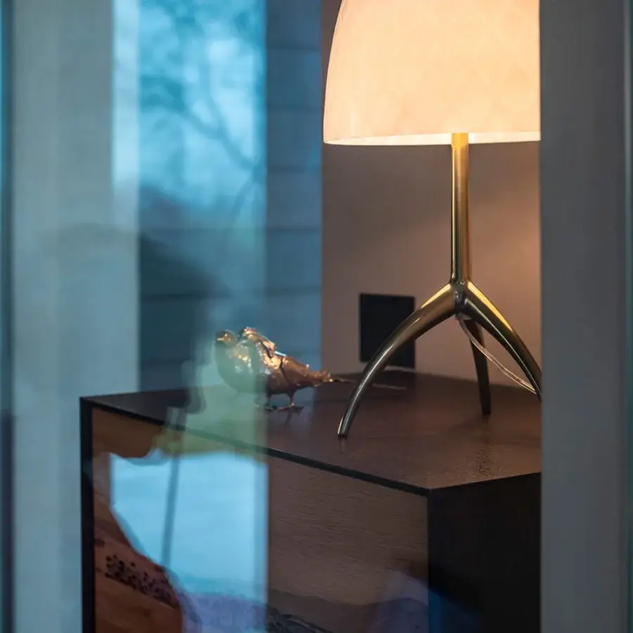 Exceptional Foscarini Lumiere table lamp with cased glass diffuser and glossy gold toned die-cast aluminum tripod base