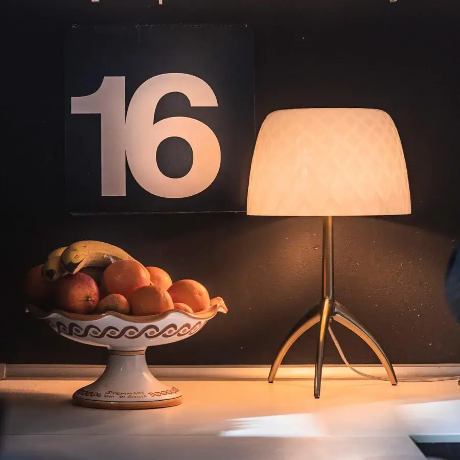 Distinguished Foscarini Lumiere table lamp with cased glass diffuser and hand-finished polished die-cast aluminum tripod base
