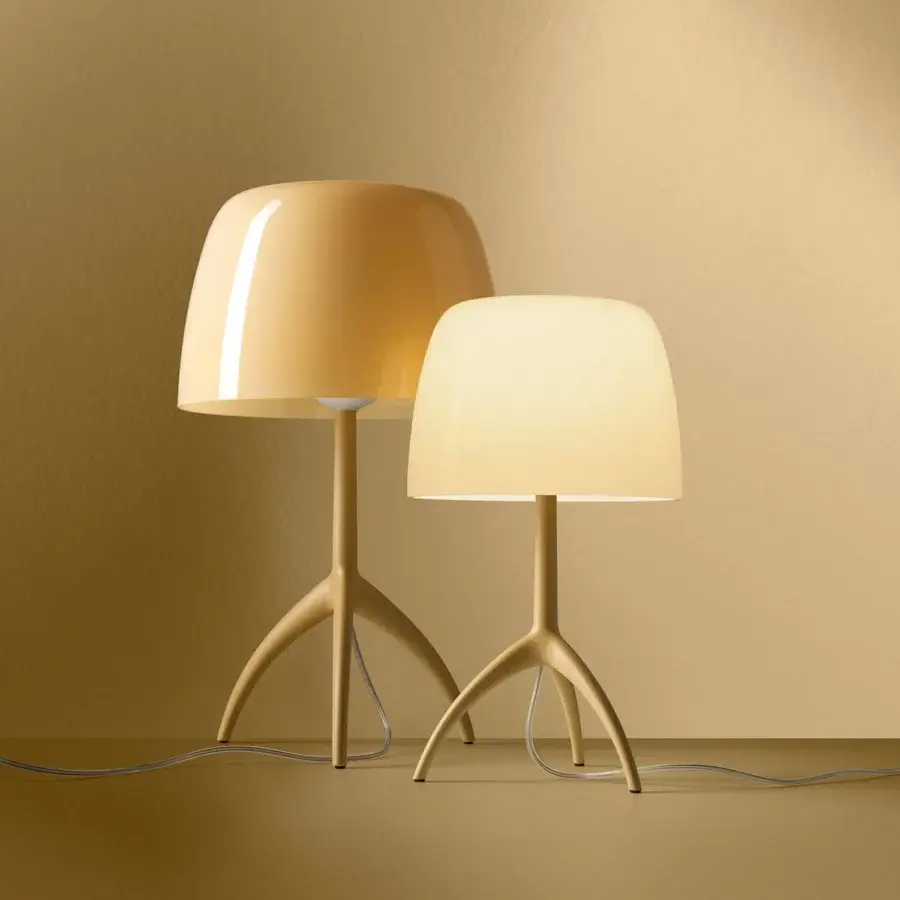 Distinguished Foscarini Lumiere Nuances lamp with warm yellowish-beige cased glass diffuser and matt liquid coated die cast aluminum tripod base