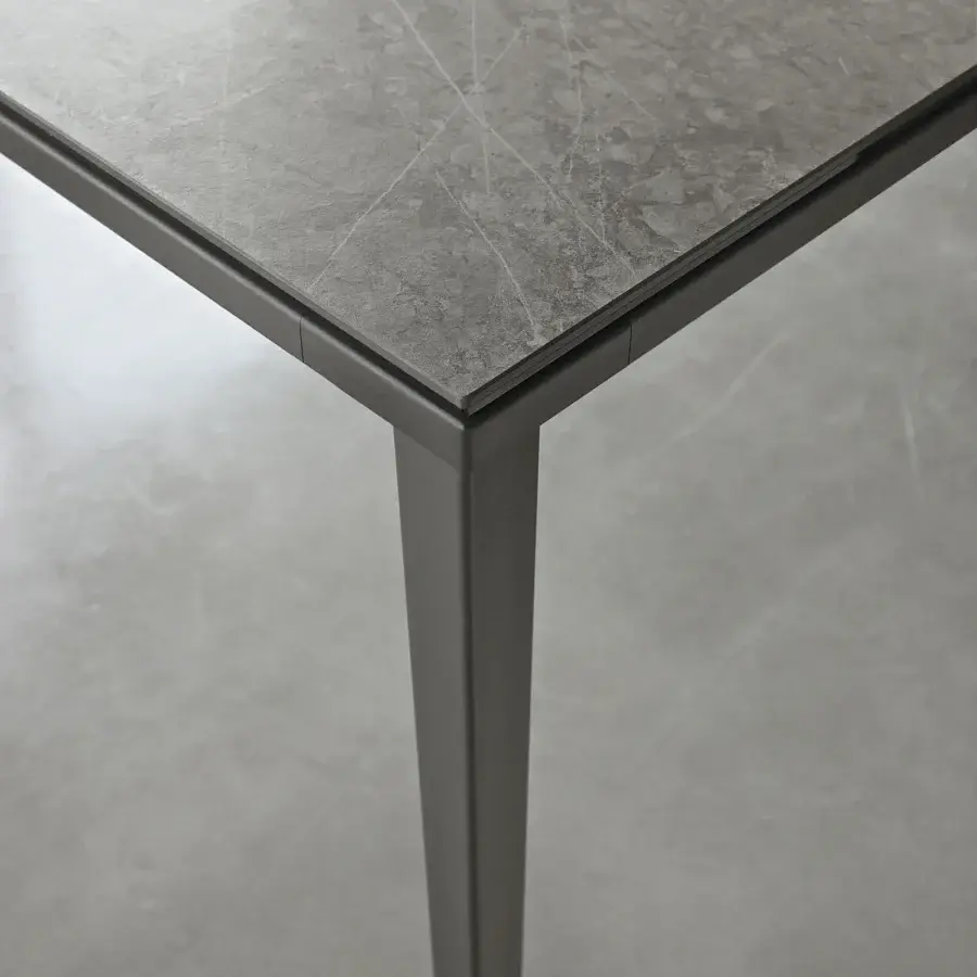 Superior Bontempi Echo extendable table with gray stone-like tabletop and sleek tapered metal legs in matte finish