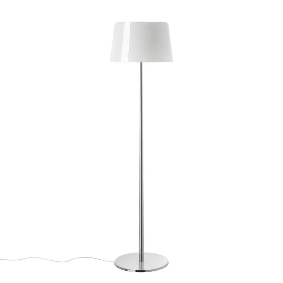Foscarini Lumiere floor lamp, polished aluminum, tall slender pole with white conical lampshade, minimalist modern design.