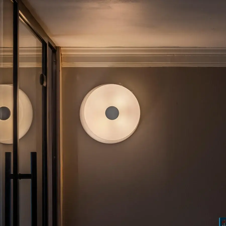 Elegant Foscarini Lumiere wall lamp with hand-blown cased glass diffuser and glossy white epoxy powder-coated metal mount