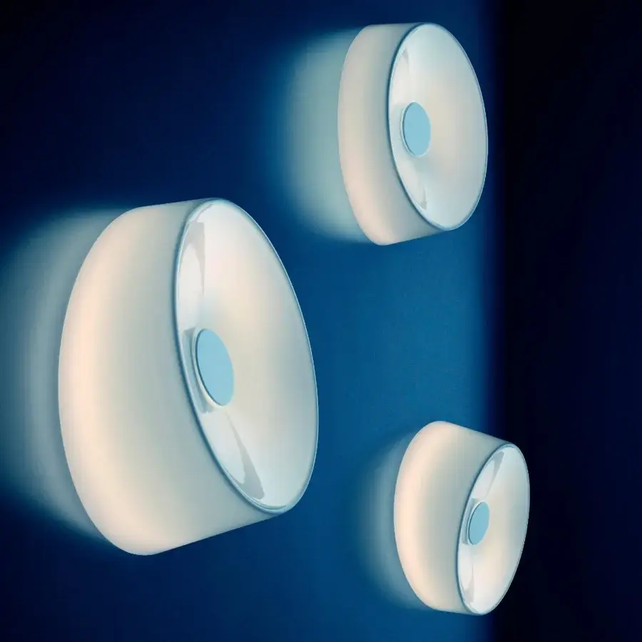 Distinguished Foscarini Lumiere wall lamp with hand-blown cased glass diffuser and glossy finish in translucent white with a light blue accent