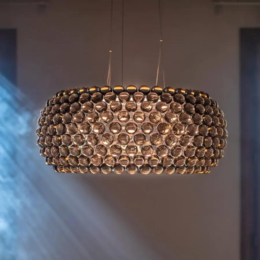 Exceptional Foscarini Caboche Plus suspension lamp crafted with transparent arches and PMMA spheres in a golden honeycomb structure with aluminum base and powder coating