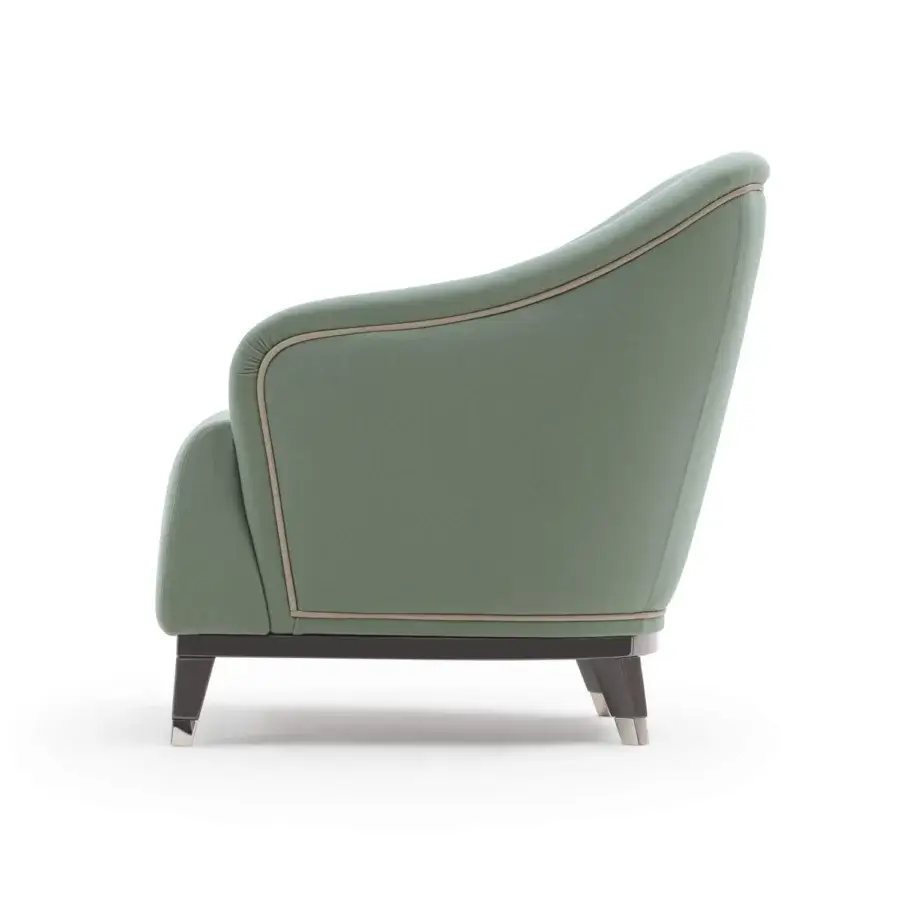 Sophisticated Turri Jolly lounge chair with enveloping lines upholstered in muted green textile and dark tapered legs