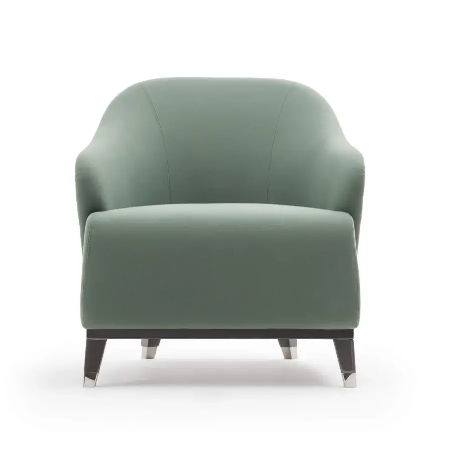 Refined Turri Jolly lounge chair with enveloping lines upholstered in muted green textile and dark wooden legs