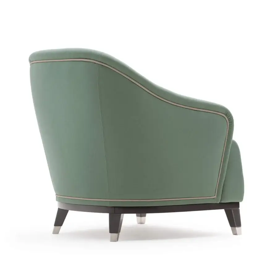 Sophisticated Turri Jolly lounge chair upholstered in muted green textile with lighter tone piping and dark wood legs