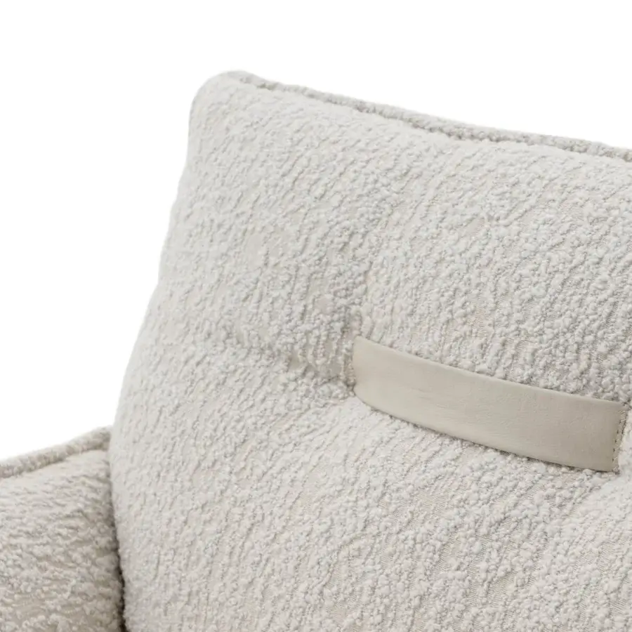 Stylish Turri Silhouette lounge chair with enveloping lines and soft off-white textured textile upholstery with leather strap detail