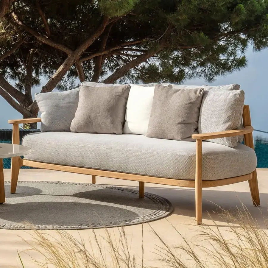 Distinguished Talenti Ever sofa with light wood frame and gray textured textiles complemented by white cushions
