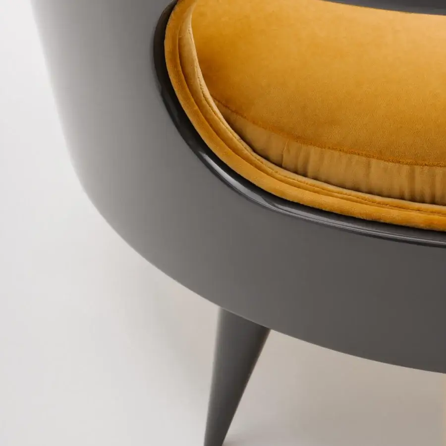 Distinguished Turri Miller lounge chair with wooden back wrapping soft mustard yellow textile and glossy dark gray frame