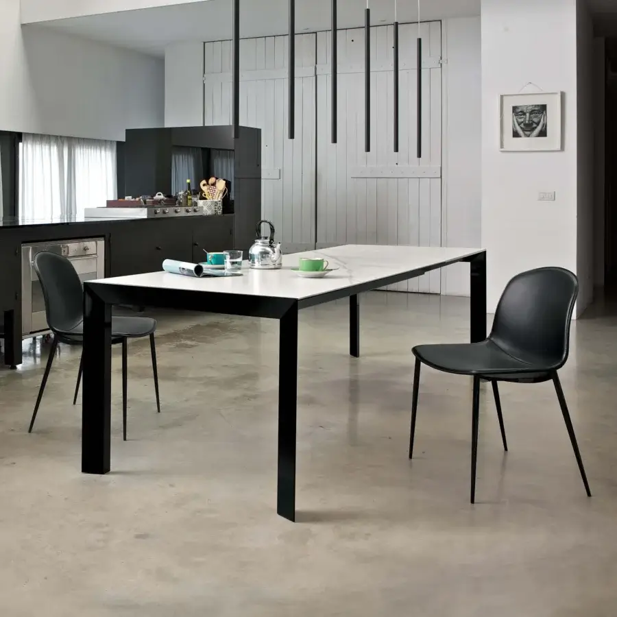 Elegant Bontempi Genio extendable table with bright white faux marble effect tabletop and bold black metal legs crafted with a glossy finish