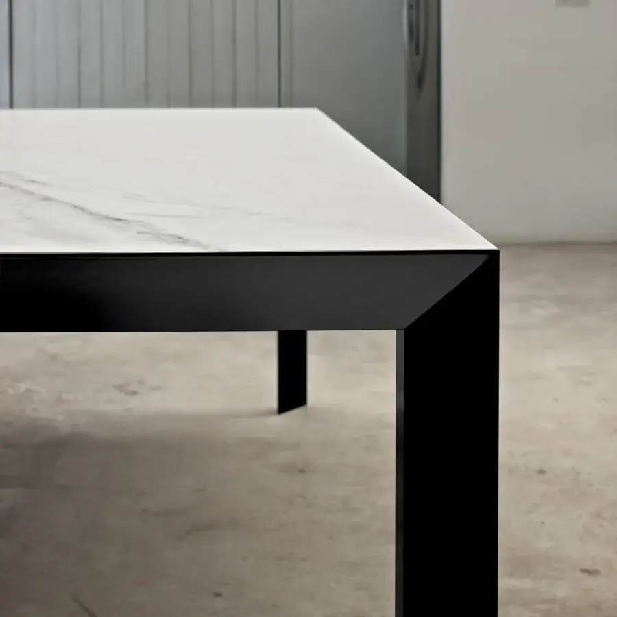 Distinguished Bontempi Genio extendable table with white stone-like tabletop and sleek black metal frame built with a glossy sheen