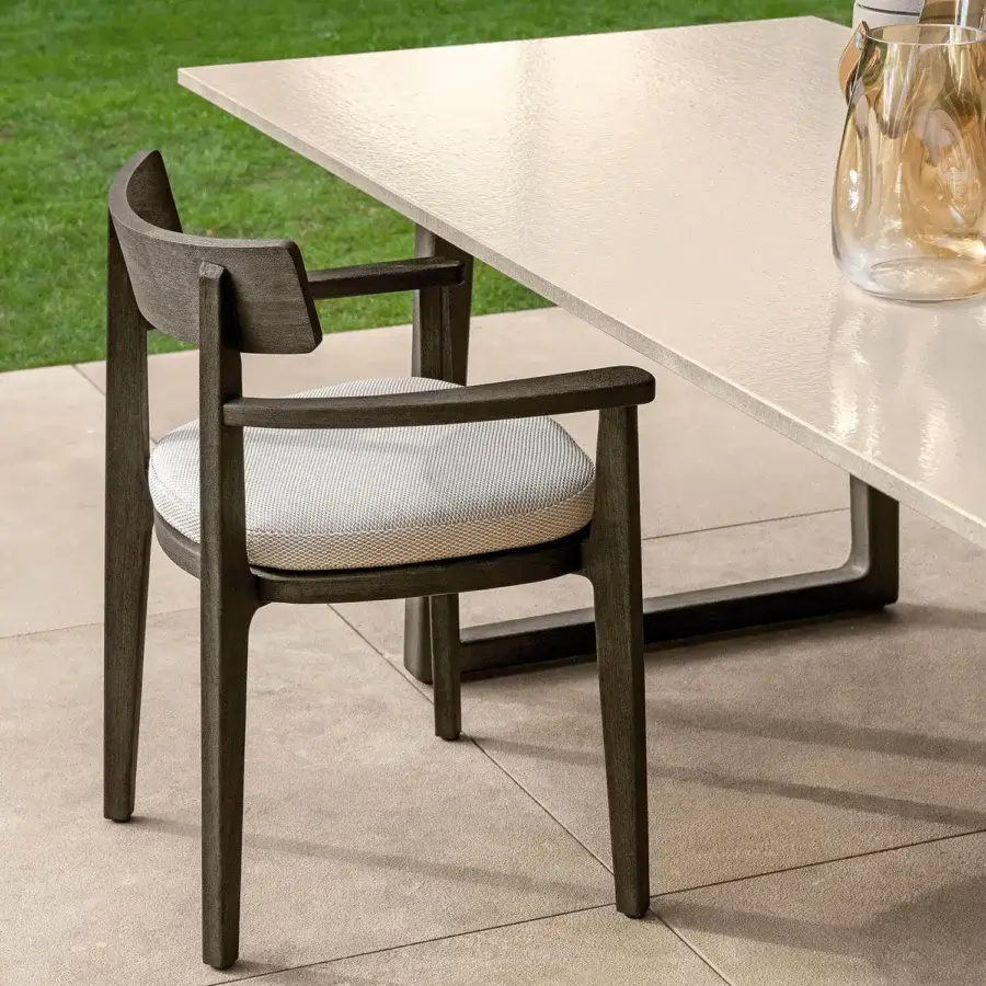 Elegant Talenti Ever table with light-colored textured surface and dark U-shaped base crafted in Italy