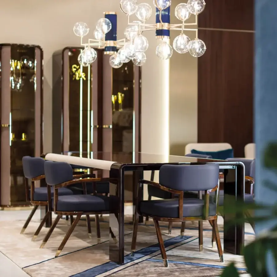 Distinguished Turri Madison armchair with dark blue upholstery and lustrous lacquered wood built with light gold metal feet
