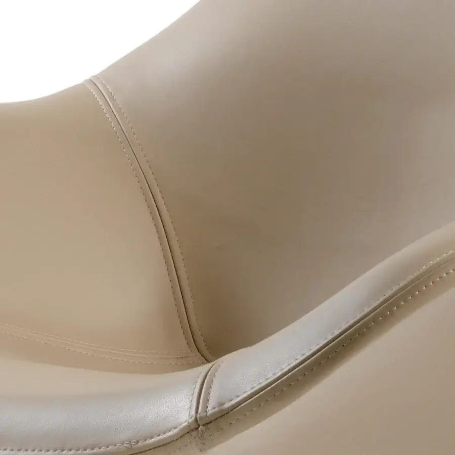 Elegant Reflex Zenith lounge chair with curved lines and smooth synthetic leather upholstery in a monochromatic beige hue with a glazed stainless steel base