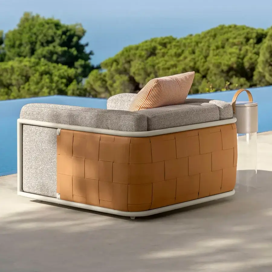 Distinguished Talenti Tressé lounge chair with woven natural tan eco-leather bands and matte aluminum frame