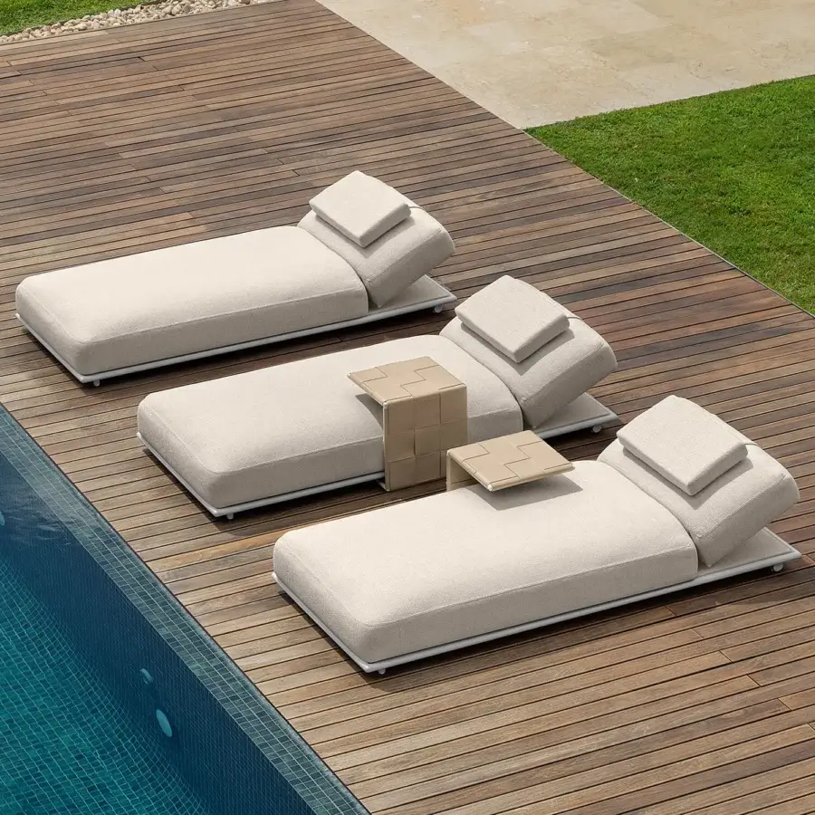 Exceptional Talenti Tressé lounger with white metal frame and woven neutral-toned cushions including a headrest and side table