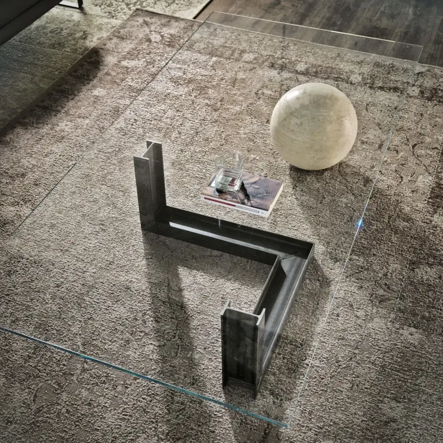 Distinguished Cattelan Italia Levante coffee table with a sleek glass top and geometrically shaped matte steel base with natural travertine