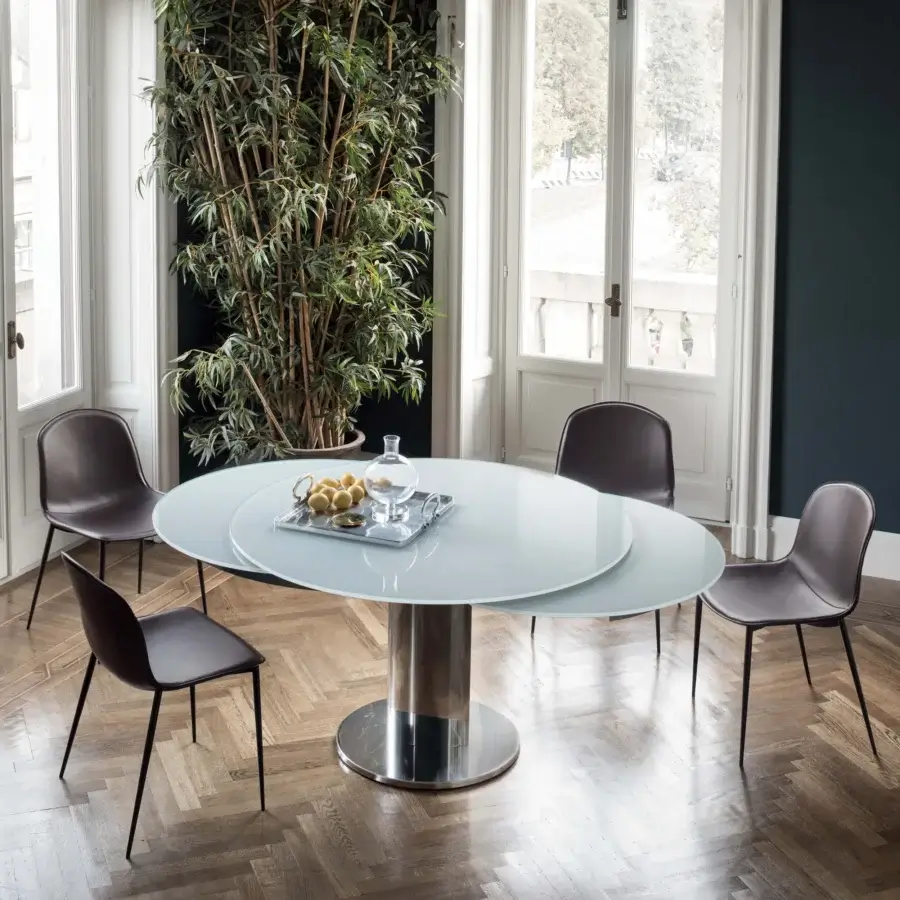 Distinguished Bontempi Giro Extendable Table with translucent white glass tabletop and shiny silver cylindrical metal base crafted in Italy