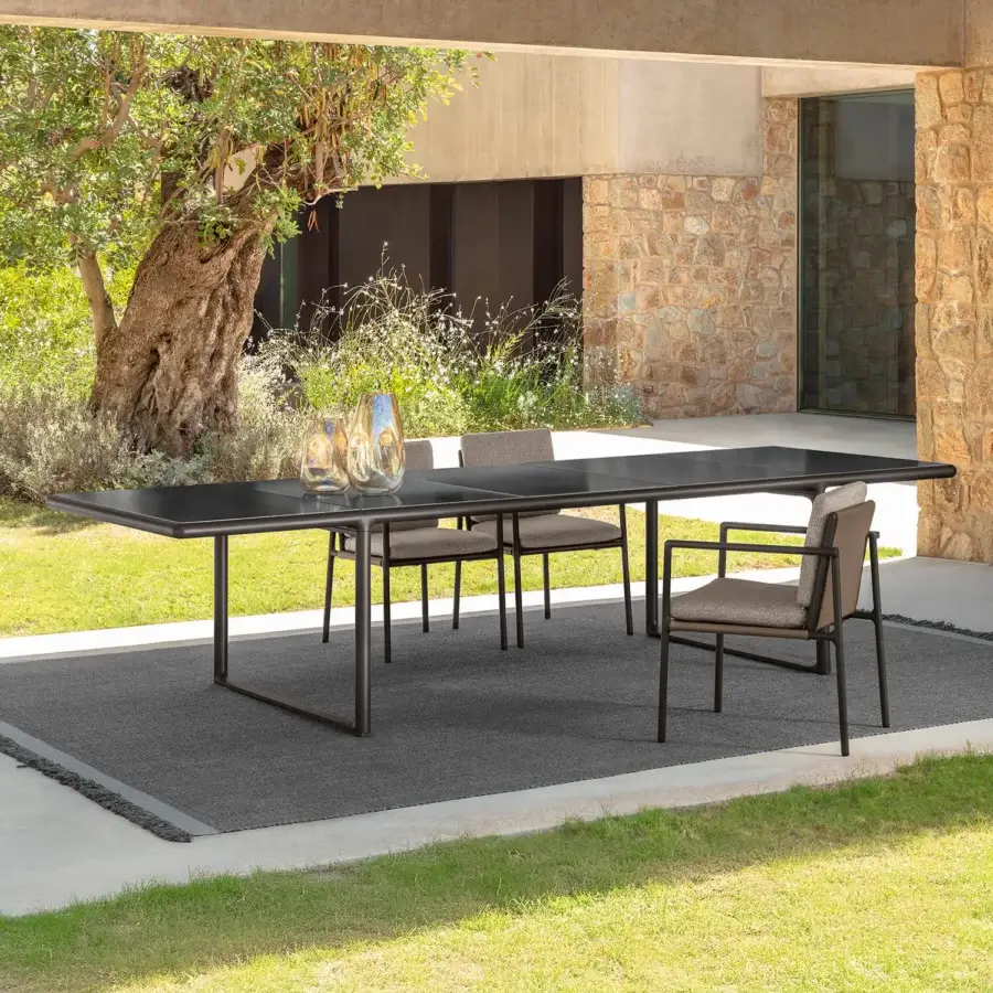 Distinguished Talenti Tressé table with dark glazed lava stone top and sleek tubular aluminum structure crafted in Italy