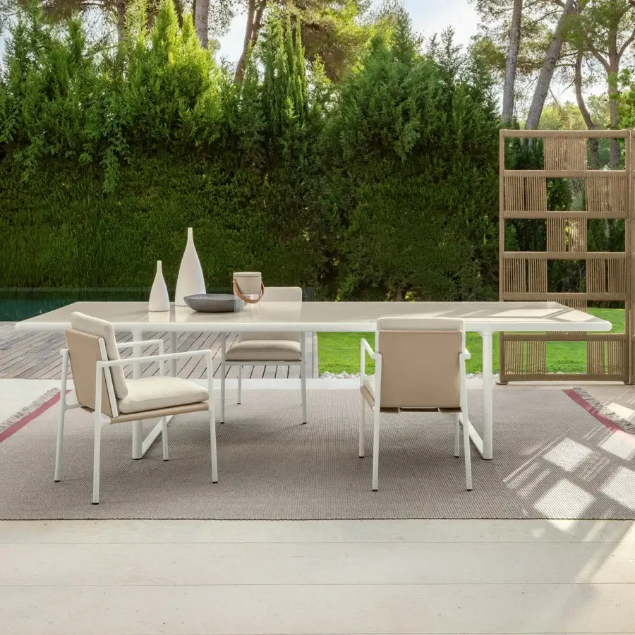 Distinguished Talenti Tressé table crafted in glazed lava stone with a sleek white tubular aluminum structure for unforgettable outdoor dining