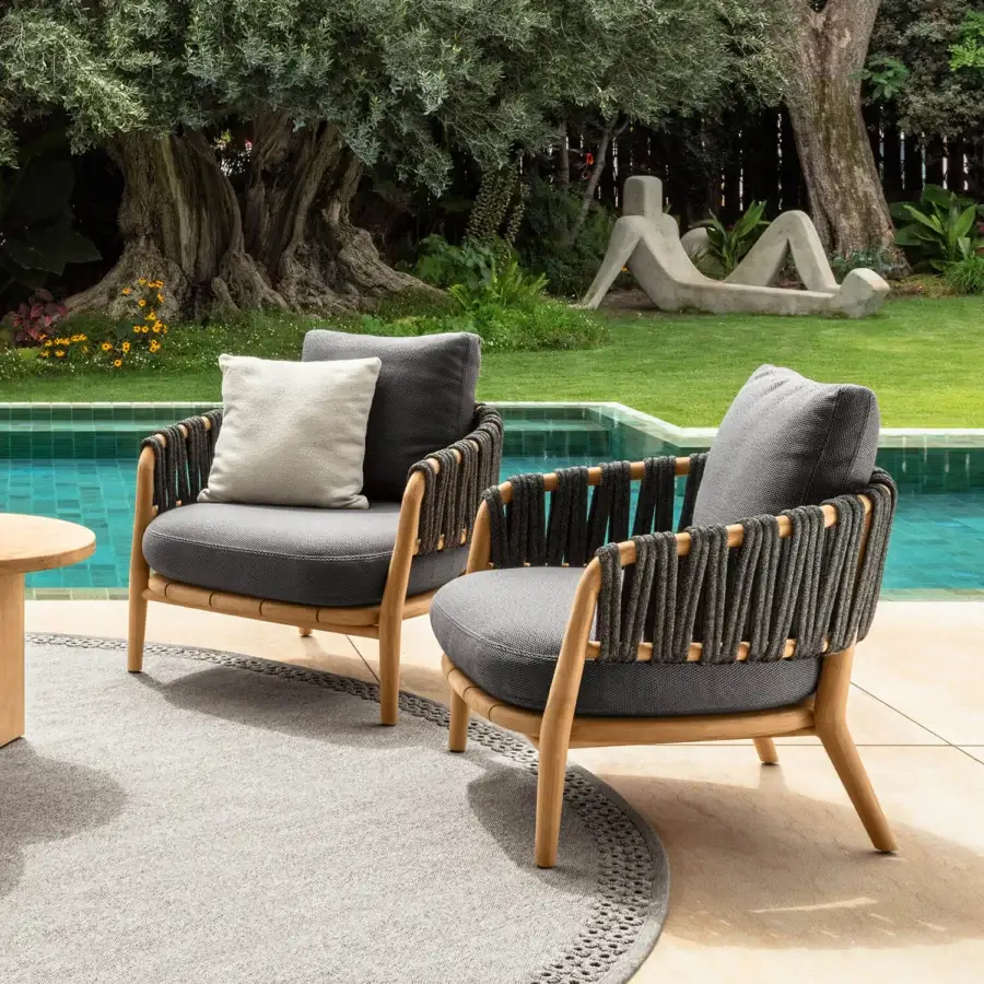 Distinguished Talenti Venice lounge chair with light teak wood frame and dark grey textile cushions offering a braided rope back