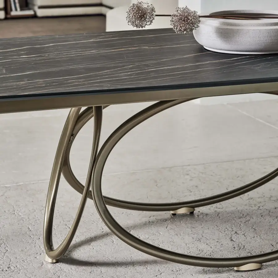 Distinguished Bontempi Louis Barrel table with a dark marbled top and bronze-toned metal frame built with interconnected curved supports