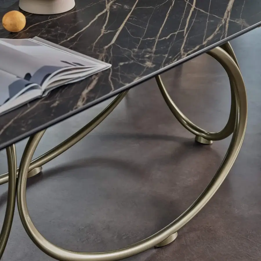 Distinguished Bontempi Louis Barrel table with a dark marble-like top and intertwining champagne-gold metal ovals in a glossy finish