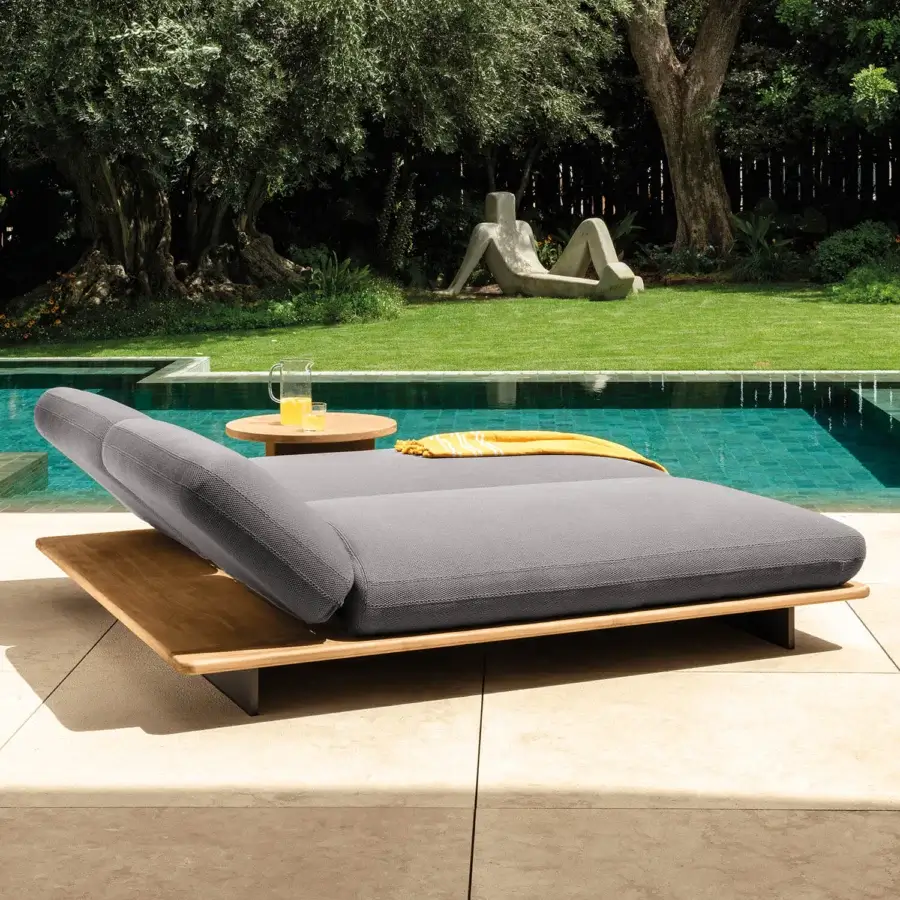 Distinguished Talenti Venice lounger with soft lines and durable gray fabric built on warm brown teak wood evoking artisan finishes