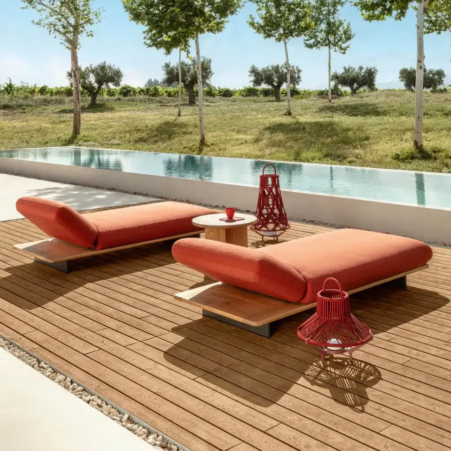 Distinguished Talenti Venice lounger with reddish-orange fabric cushions and artisan teak wood bases evokes lightness with its contemporary design