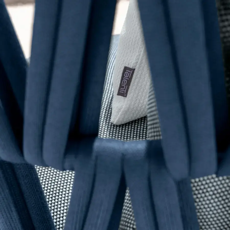 Distinguished Talenti Swipe sofa expresses lightness with deep blue textile and a dynamic padded rope weave aluminum backrest