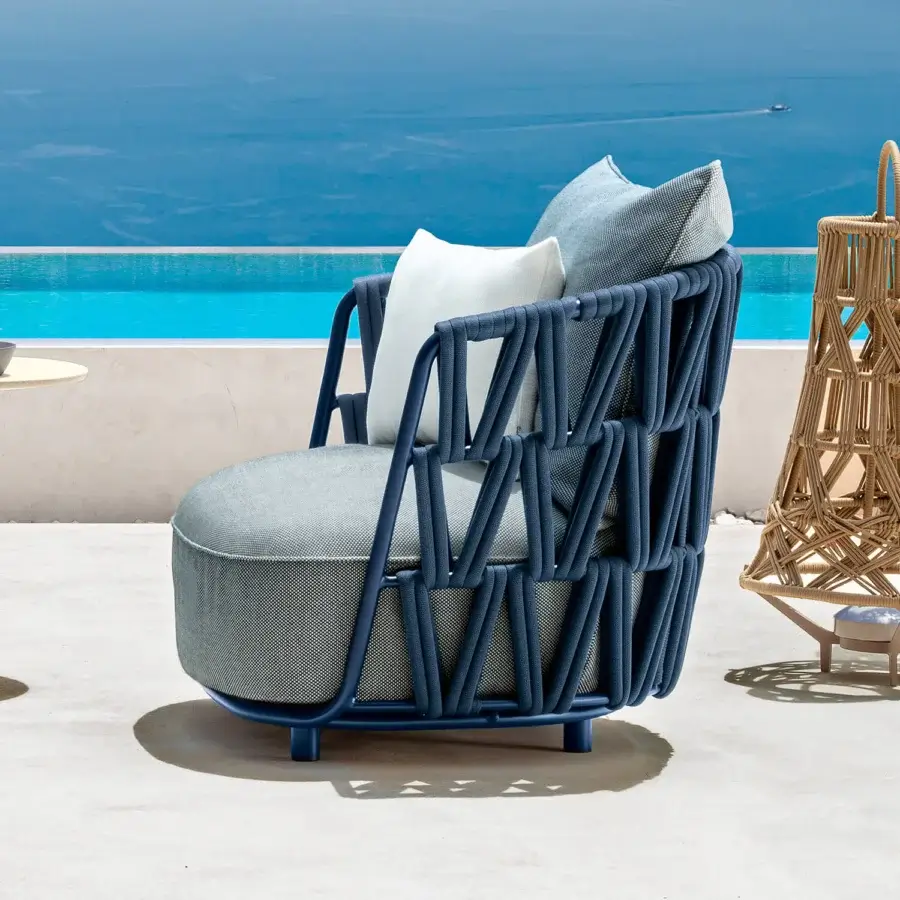 Distinguished Talenti Swipe lounge chair with blue synthetic frame and light gray cushions woven in textured rope detailing