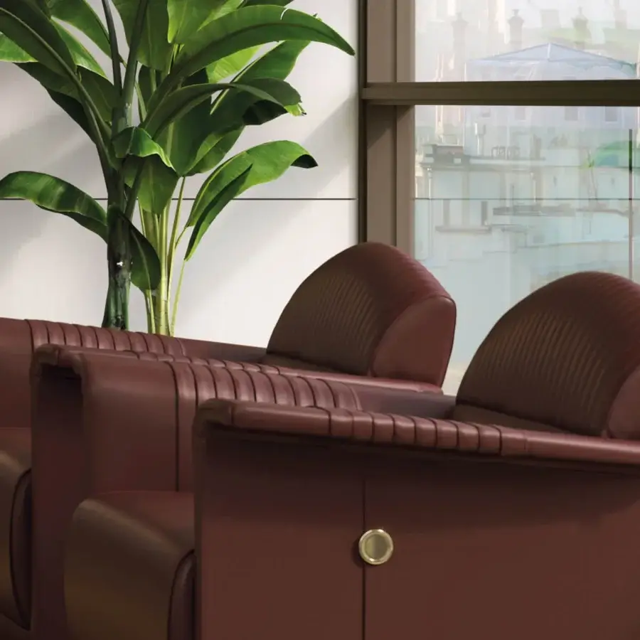 Distinctive Turri Madison lounge chair upholstered in smooth brown leather with vertical stitched segments and metallic detail