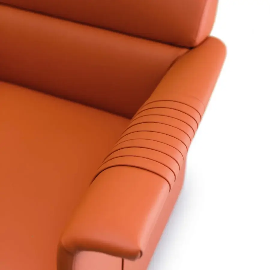 Distinguished Turri Madison lounge chair upholstered in smooth reddish-orange synthetic leather with horizontal stitched detailing crafted in Italy