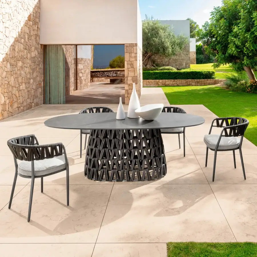 Distinguished Talenti Swipe armchair with a lightweight aluminum frame and light gray cushioned seat woven in a geometric padded rope design with dark metal legs and matte finish