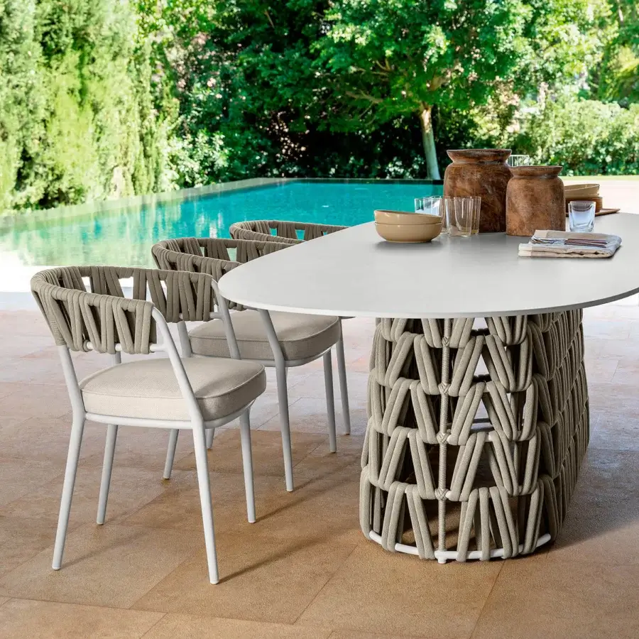 Distinguished Talenti Swipe armchair with a lightweight aluminum frame and comfortable light gray textile cushioning, highlighted by a dynamic padded rope weave