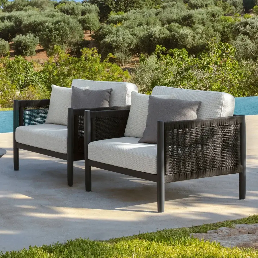 Elegant Talenti Dolcevita Alu lounge chair with dark metal frame and woven textile panels complemented by light-colored cushions crafted in Italy