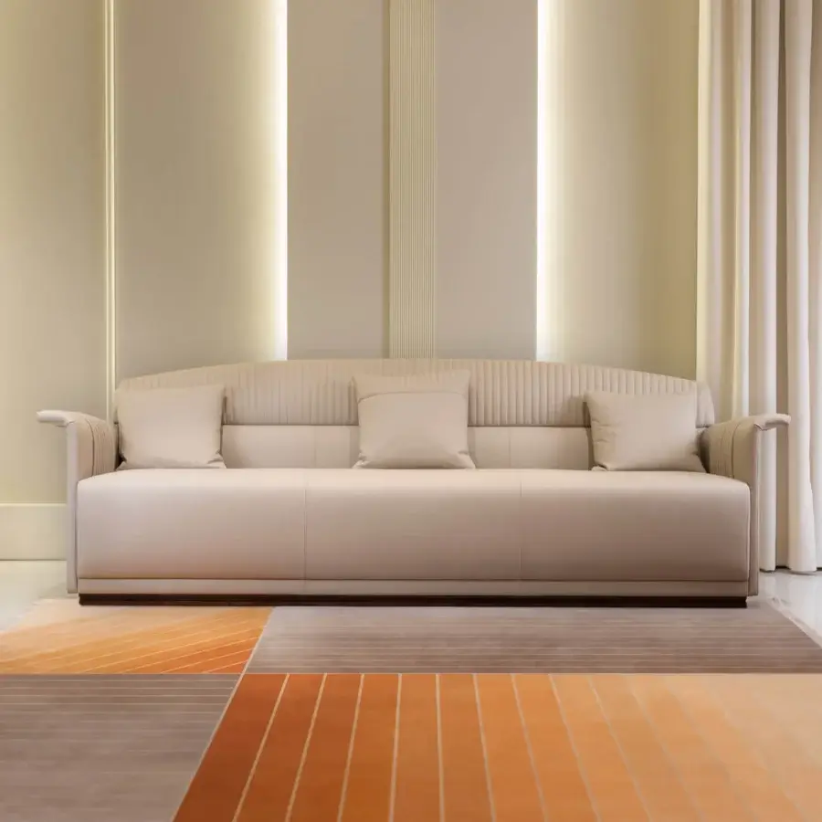 Distinguished Turri Madison sofa with light beige textile upholstery and vertical stitched detailing on a dark brown finished wooden base