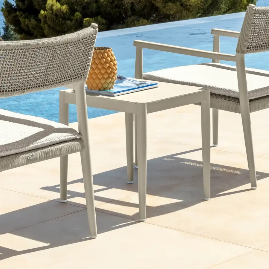 Distinguished Talenti Dolcevita Alu side table with square top and slender legs in neutral beige with matte finish