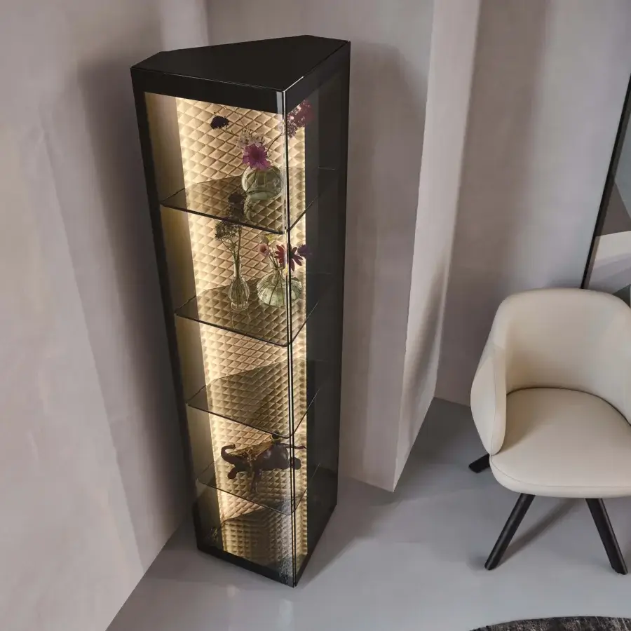 Elegant Cattelan Italia Atelier showcase with triangular form, smoked glass shelves and diamond-quilted leather backdrop illuminated by integrated lighting