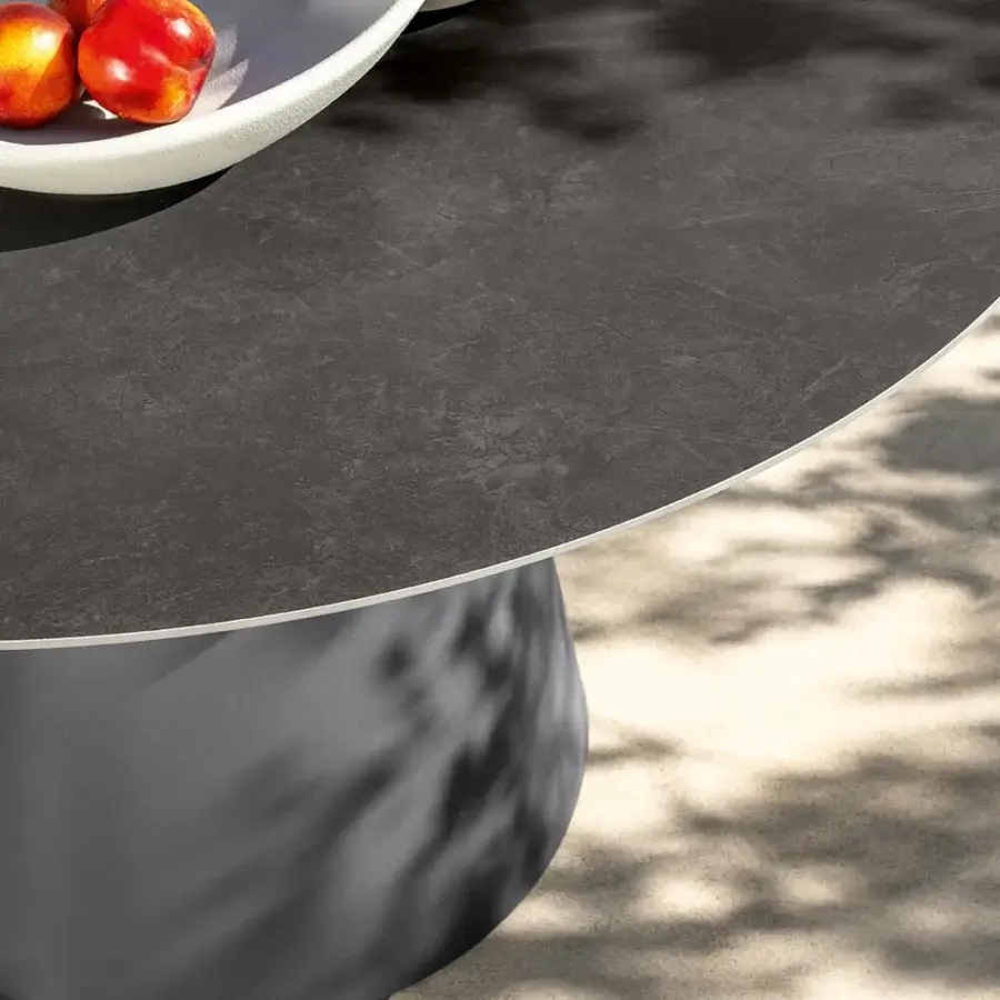 Distinguished Talenti Dolcevita Alu table with dark gray stoneware top and light gray conical aluminum base in a subtly textured matte finish