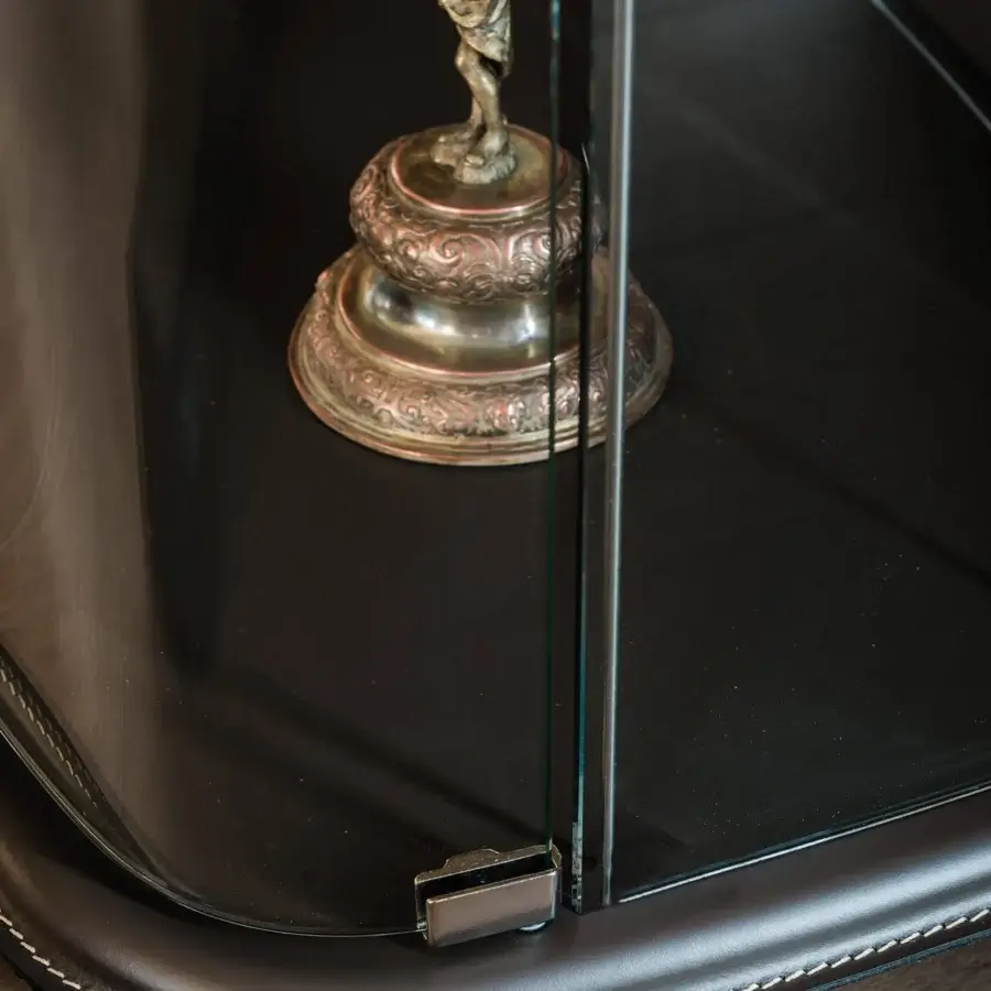 Distinguished Cattelan Italia Concerto showcase with transparent extra-clear glass and dark leather upholstery offering a striking contrast