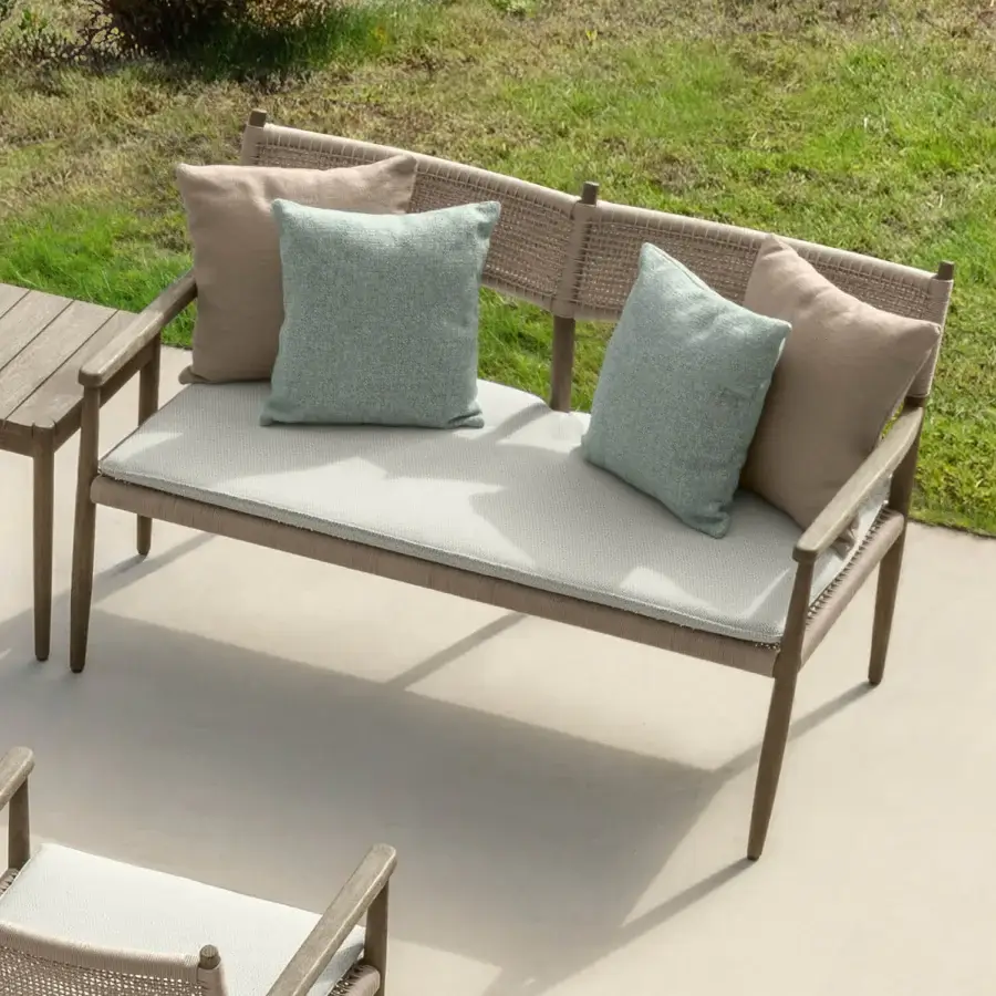 Distinguished Talenti Dolcevita Wood love seat sofa with light brown wood and woven rope detailing, complemented by light gray cushions and pillows