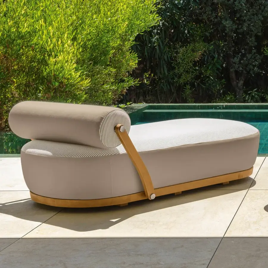 Distinguished Talenti Nami lounger with light beige textile upholstery, warm teak wood arm supports and a matching base