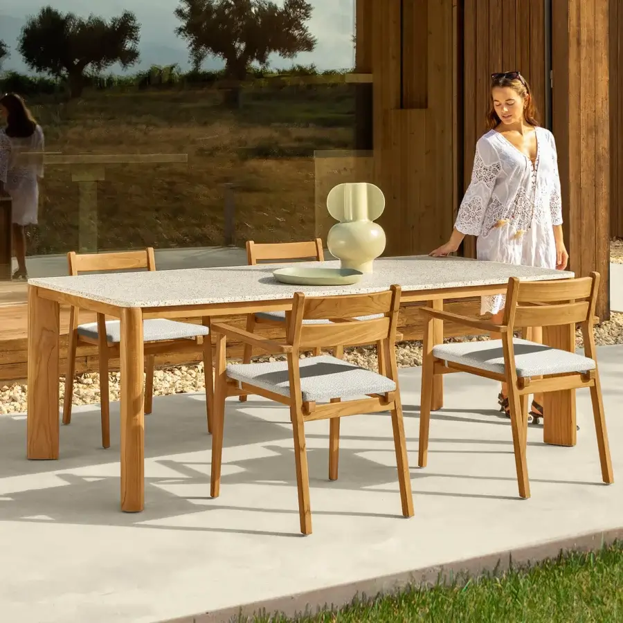 Superior Talenti Oliver table with grit tabletop and solid teak wood base in a warm matte finish