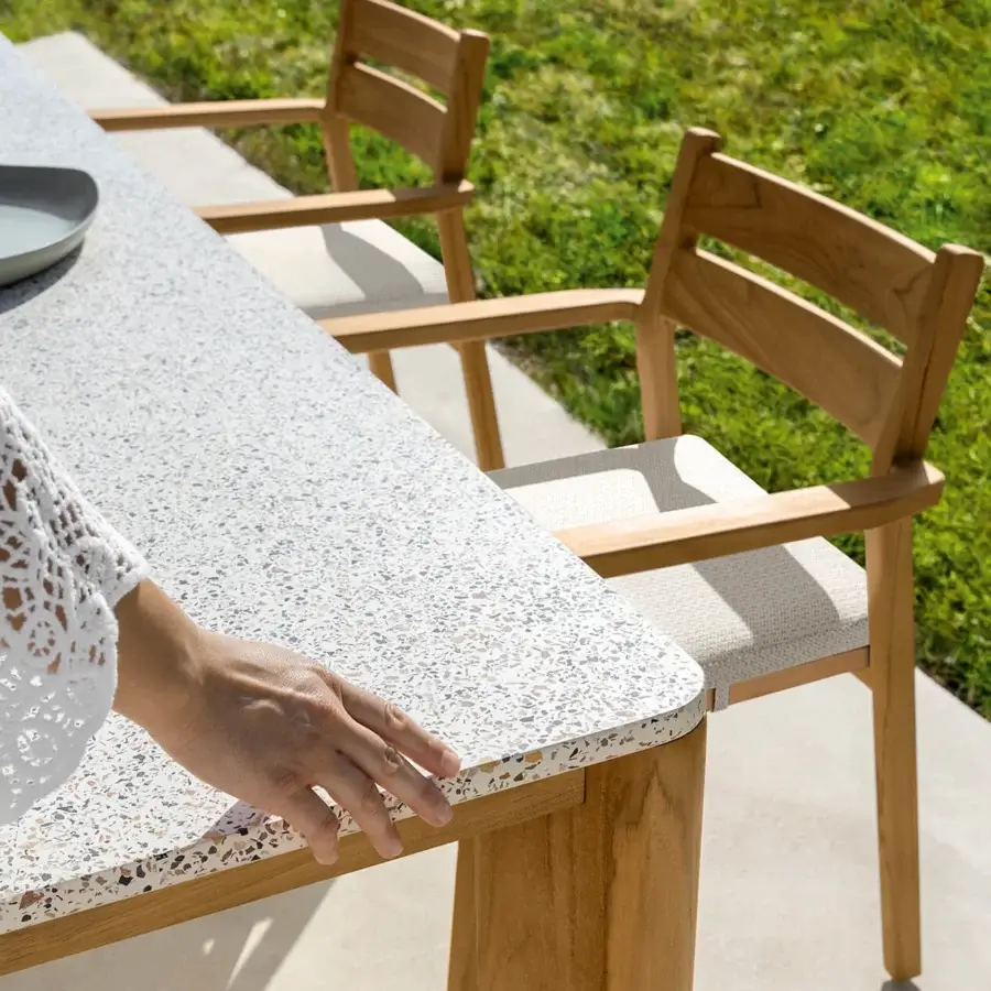 Superior Talenti Oliver table with teak wood frame and grit top exhibiting a speckled white and grey smooth finish
