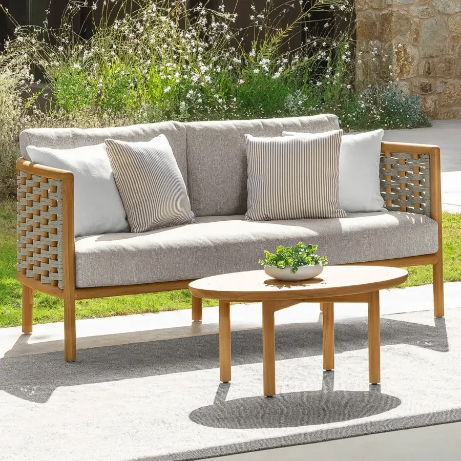 Sophisticated Talenti Prichi sofa with teak wood frame woven in intricate rope and light gray cushions with striped beige pillows