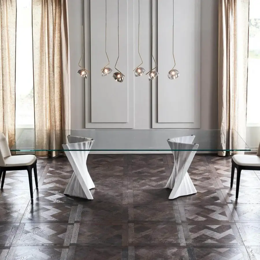 Distinguished Cattelan Italia Plisset table with clear glass tabletop and Palissandro white marble bases crafted in smooth geometric forms