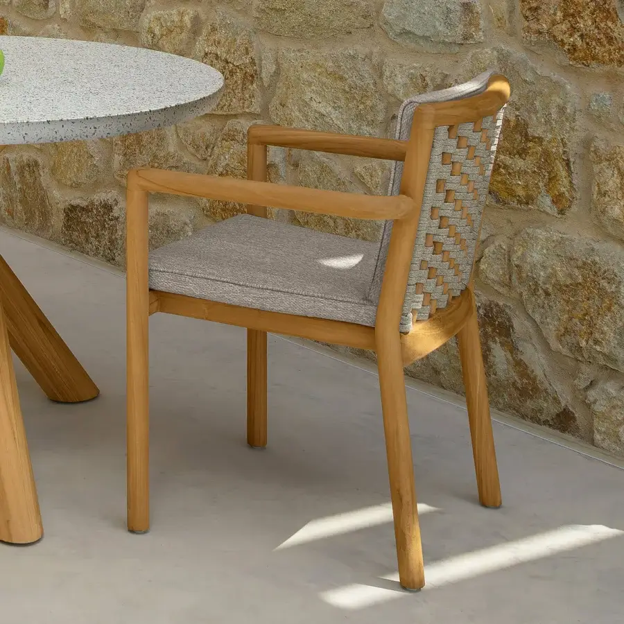 Superior Talenti Prichi armchair with woven ropes and a teak frame, complemented by a medium gray textile seat cushion