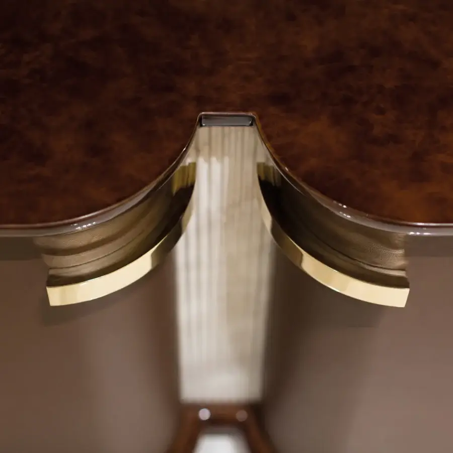 Superior Turri Madison TV stand with glossy wood and brass detailing, exhibiting curved lines and a textured light interior